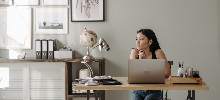 A woman deciding what stays and what doesn't on her laptop. 