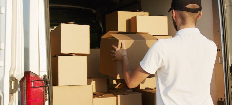man packing boxes into a van