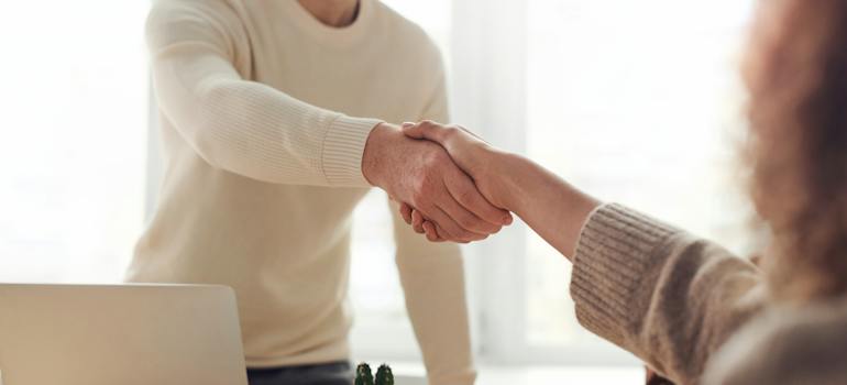 two people shaking their hands after moving from St. Petersburg to Lehigh Acress