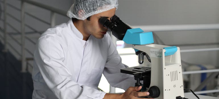 a doctor looking at microscope
