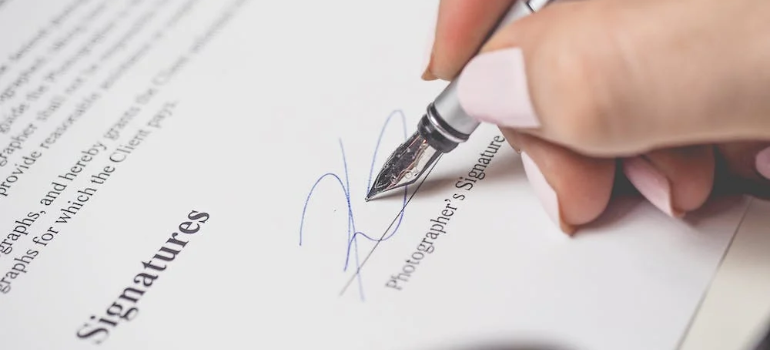 A person signing an insurance deal