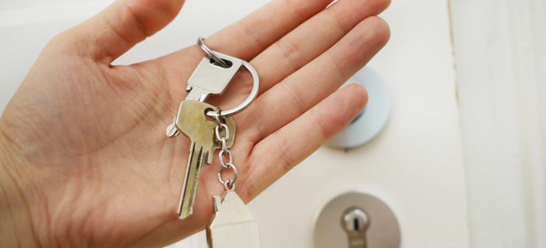 A hand holding the keys to a property