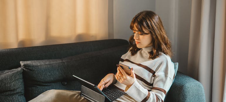 a woman reading on a laptop about how to keep your traditions alive in a new place