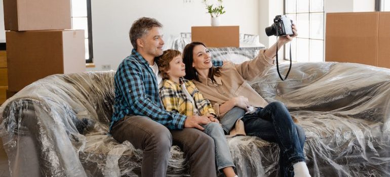 A family taking a selfie while sitting on the sofa