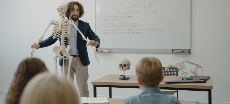 after moving from Tampa to Tallahassee teacher teaches anatomy with the help of a skeleton