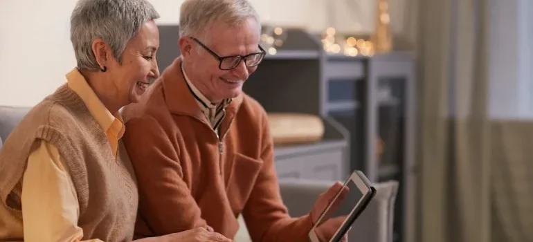 Two seniors watching their tablet