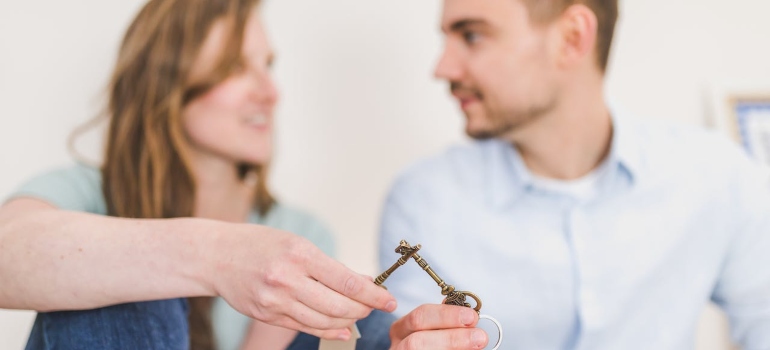 A woman and a man cross keys