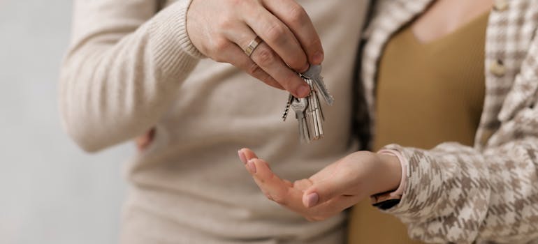 A couple with house keys in their hands