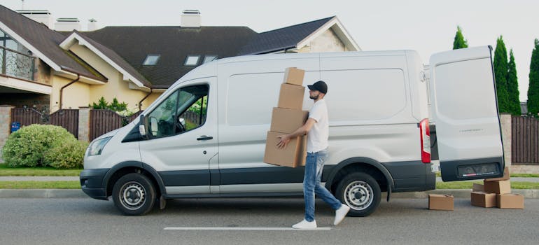 A professional mover unloading a white van