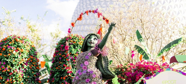 A statue of a woman in a flower garden in Orlando. 