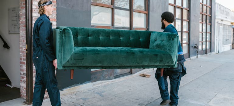 two men carrying the couch