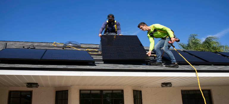 A man installing solar panels.