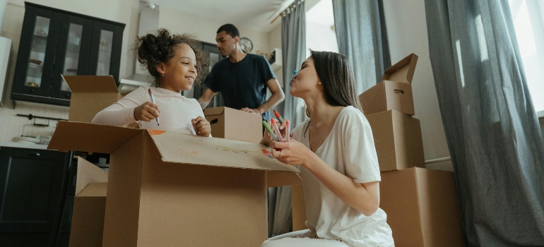 a family following the unpacking guide for families