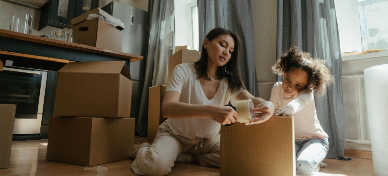 a mother and her daughter following the unpacking guide for families