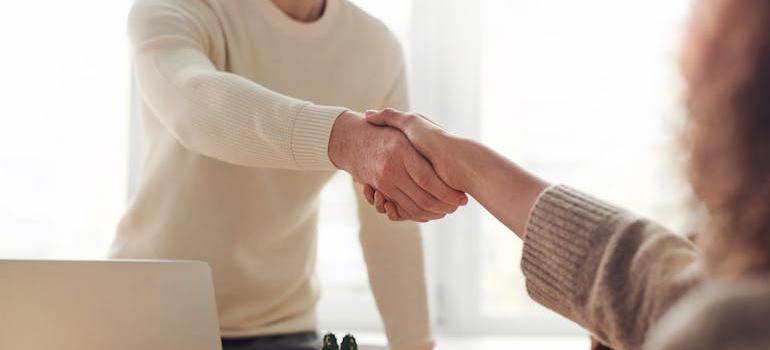 two people shaking hands, when moving from Davie to Tampa