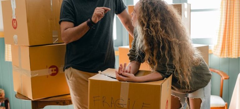 a man and a woman after they decide to find a home in Tallahassee, packing boxes for the move to Tallahassee