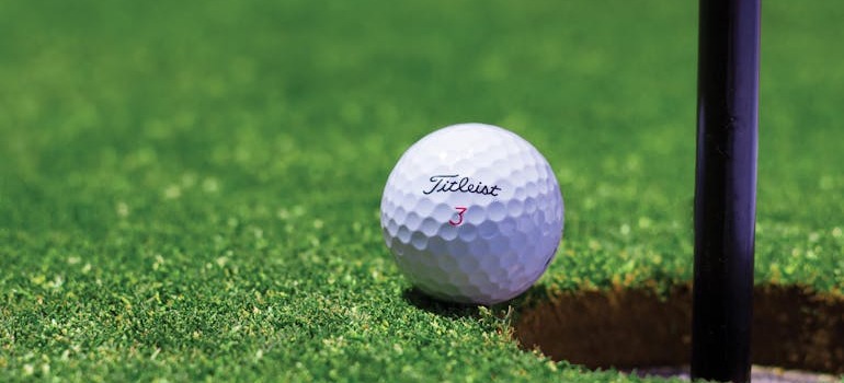 A golf ball by the hole