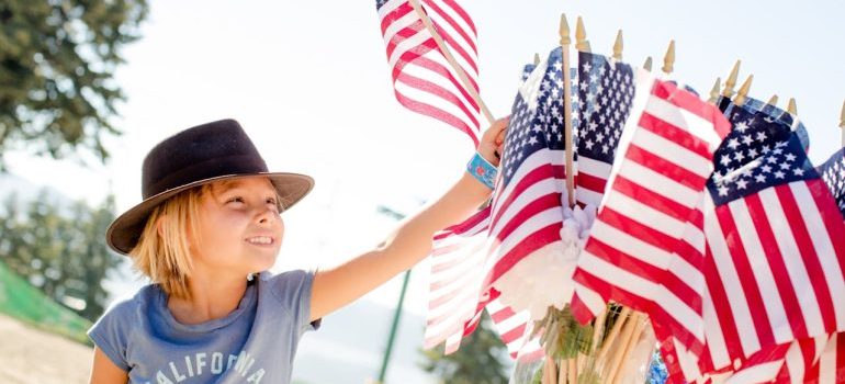 a kid with hat and flags