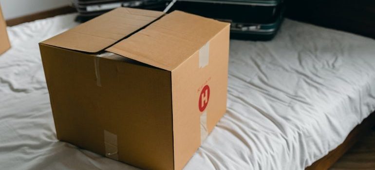 a box on the bed with white sheet