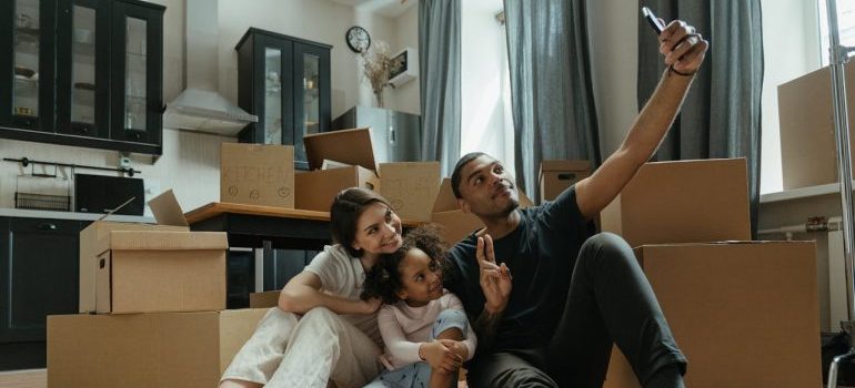 A family having fun while packing and waiting for long distance movers Connecticut