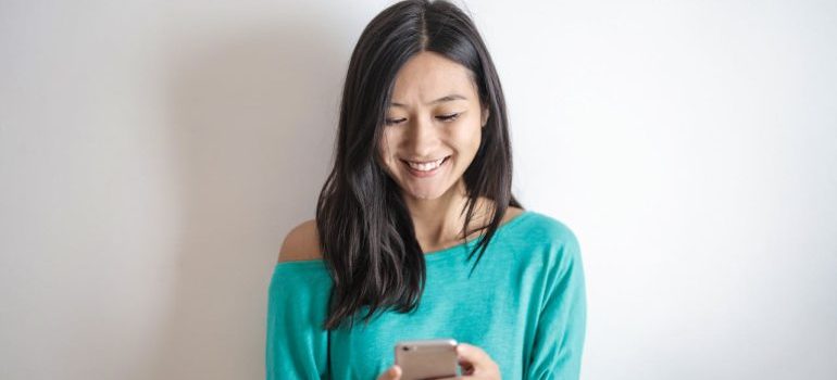 A woman contacting one of the interstate moving companies Connecticut​