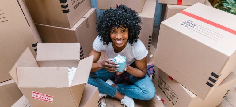 A woman sitting among boxes